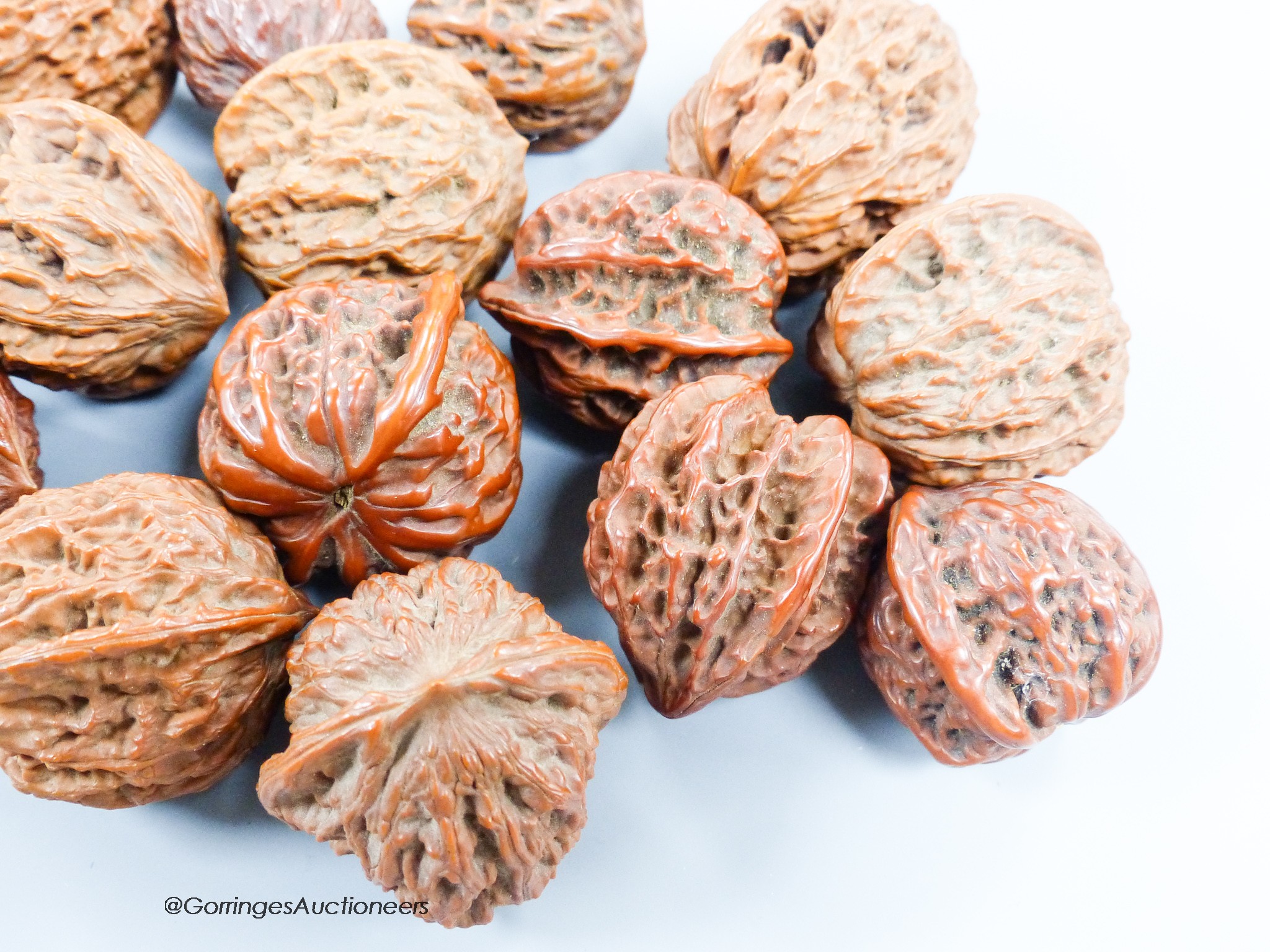 A quantity of walnuts and a Balinese coconut shell heart shaped panel